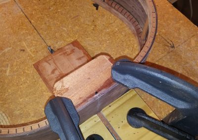 000-12 Neck rod adjustment channel being drilled