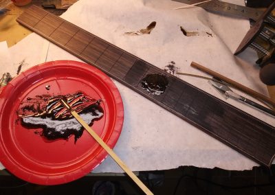 Fretboard Inlay being epoxied