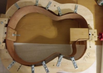 Neck and tail blocks are installed and mold has been adjusted for the 000-12 shape to support sides while lining is installed