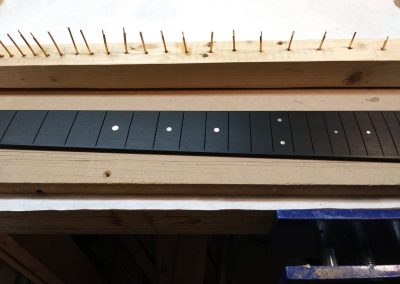 Frets being prepared for fretting