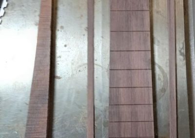 Brazillian Rosewood binding is cut from fingerboard scraps to make blind fret ends