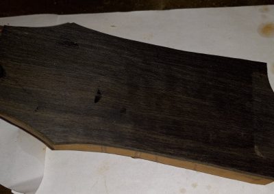 Ebony Veneer headstock plate is glued on, rough shapped, ready for final shapping