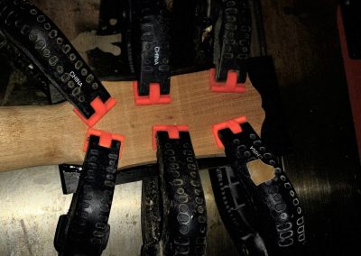 Ebony headstock veneer being epoxied on