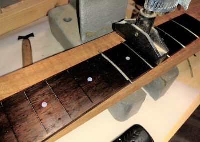 The frets are being pressed into their slots