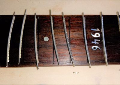 The frets are undercut to produce blind fret ends